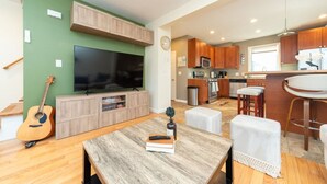 A modern kitchen with wooden cabinets, a built-in microwave, and a stainless steel sink. - Cozy Boston Homestead : Sleeps 8, Pet Friendly (Framingham)