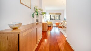 A modern kitchen with wooden cabinetry, a large bowl on the counter, and a potted plant.