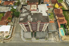 A multi-story building with a central courtyard, surrounded by other buildings.
