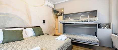 Habitación cuádruple Deluxe | Caja fuerte, cortinas opacas, sistema de insonorización