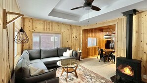A cozy living room with a sofa, coffee table, and fireplace. - Cabin @ Torch with Lake Access, Kayaks & Outdoor Shower! (Rapid City)