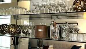 A glass display case with various glassware and kitchenware.