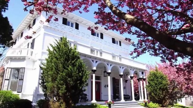 A white building with a central entrance and multiple windows. - The Hamilton Hoppin House (Middletown)
