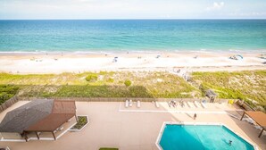 A beachfront hotel with a swimming pool, beach access, and a view of the ocean. - Respite by the Sea The Islander, King Bed, Oceanfront Condo, Pool, Tennis,Cabana (Wrightsville Beach)