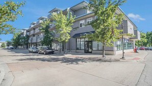A multi-story building with a modern architectural design, featuring a mix of residential and commercial spaces. - Grand Haven Getaway Welcomes You (Grand Haven)