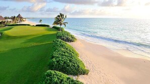 A golf course with a beach and ocean view.