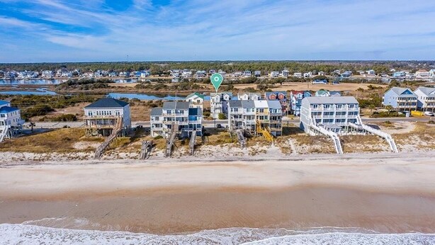 A coastal residential area with beachfront properties, including houses with decks and a beach in the foreground. - BEACH PLEASE! Amazing Ocean and Sound Views with Easy Beach Access! Pet Friendly (North Topsail Beach)