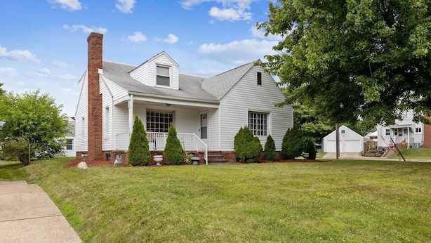 A single-story house with a brick chimney, a front porch, and a well-maintained lawn. - Walk to Pro Football Hall of Fame! 5 Bedroom (Canton)