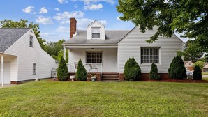 A single-story house with a front porch, a chimney, and a well-maintained lawn. - Walk to Pro Football Hall of Fame! 5 Bedroom (Canton)