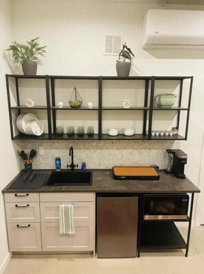 Fridge, microwave, coffee/tea maker, cookware/dishes/utensils