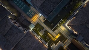 An aerial view of a modern building with a central courtyard, surrounded by traditional architecture. - Holiday Inn Express Pingchang by IHG (Bazhong)