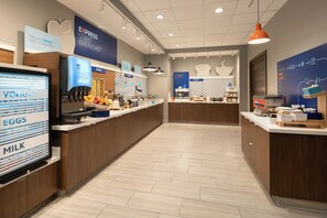 A modern breakfast area with a self-serve station, including yogurt, eggs, and milk. - Holiday Inn Express & Suites Fresno Airport by IHG (Fresno)