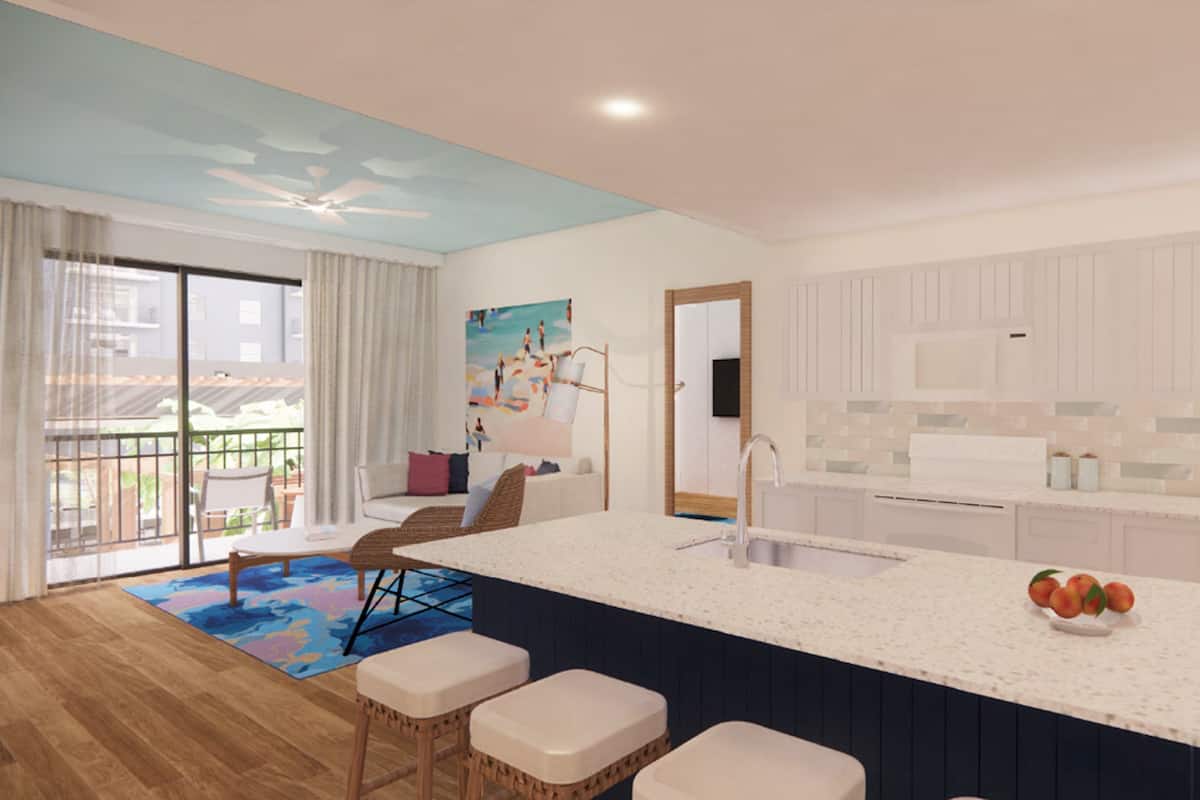 A modern kitchen with a large island, a dining area with a view, and a living room with a large window.