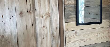 A wooden door with a black handle and a black metal latch.