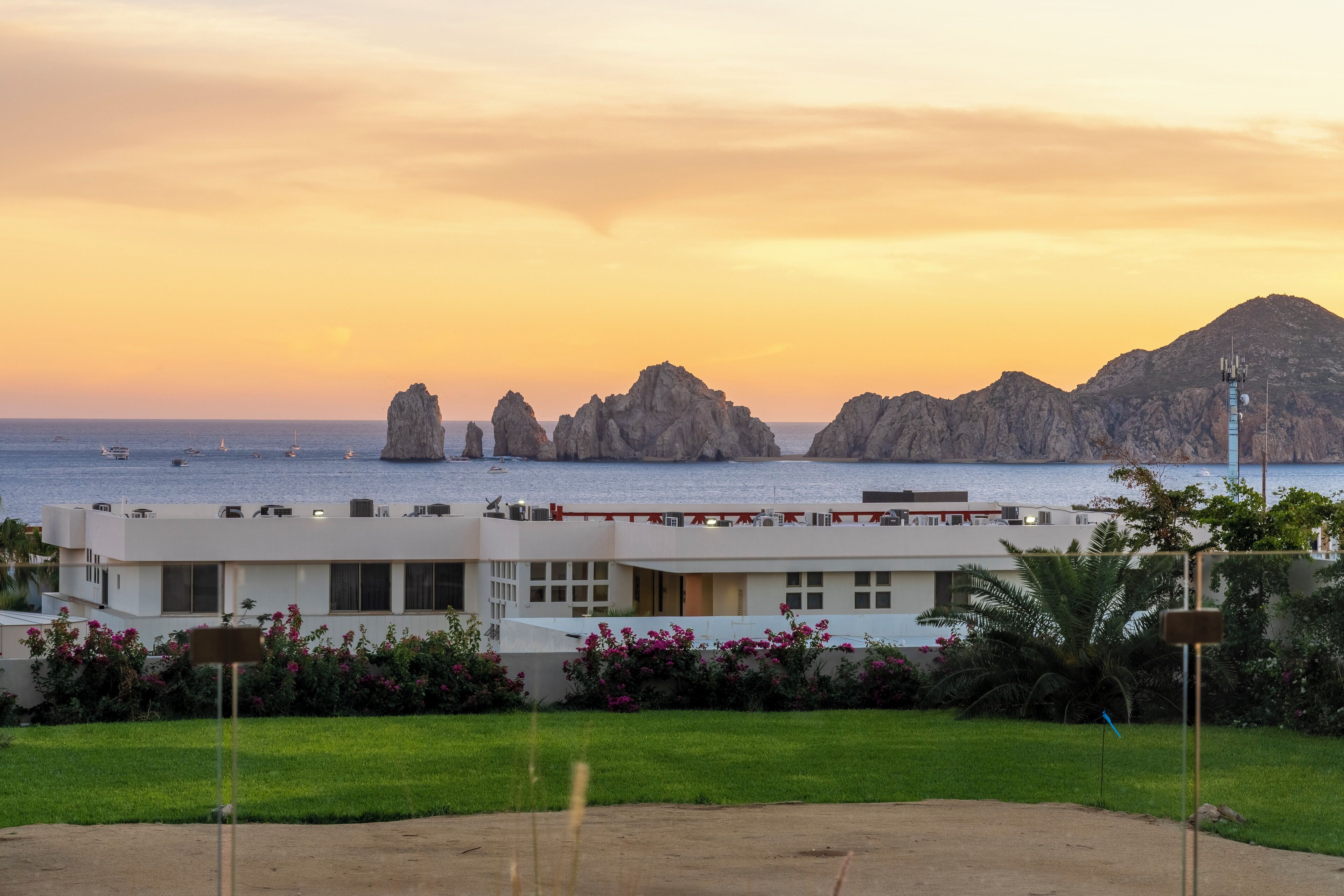 A coastal hotel with a view of the sea and rock formations.