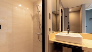 A modern bathroom with a large mirror, a sink, and a shower. - KEIKYU EX HOTEL MINATOMIRAI YOKOHAMA (Yokohama)
