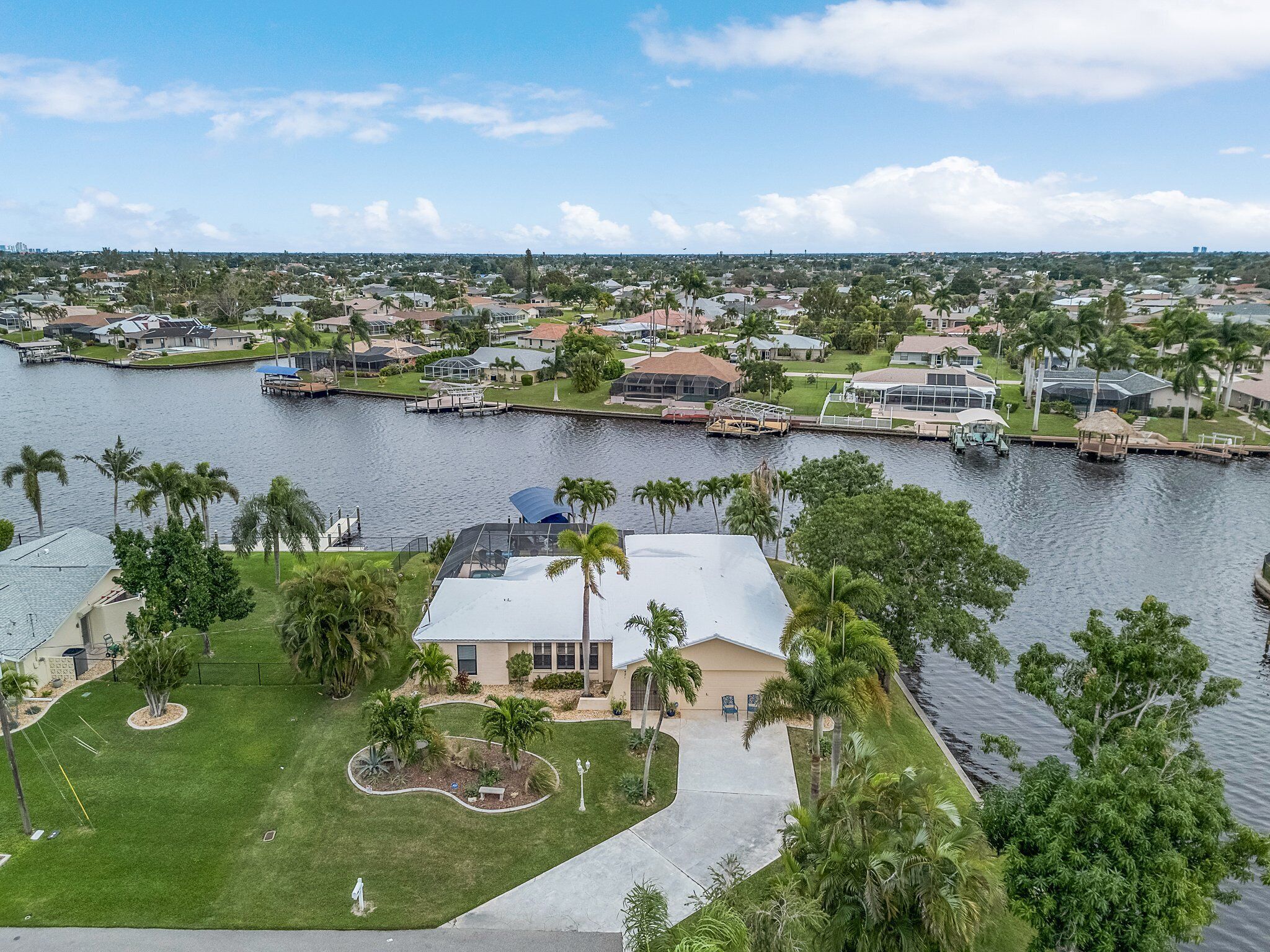 A residential area with houses, a marina, and a river.