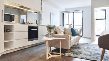 Deluxe Apartment | Living area | 55-inch LED TV with cable channels