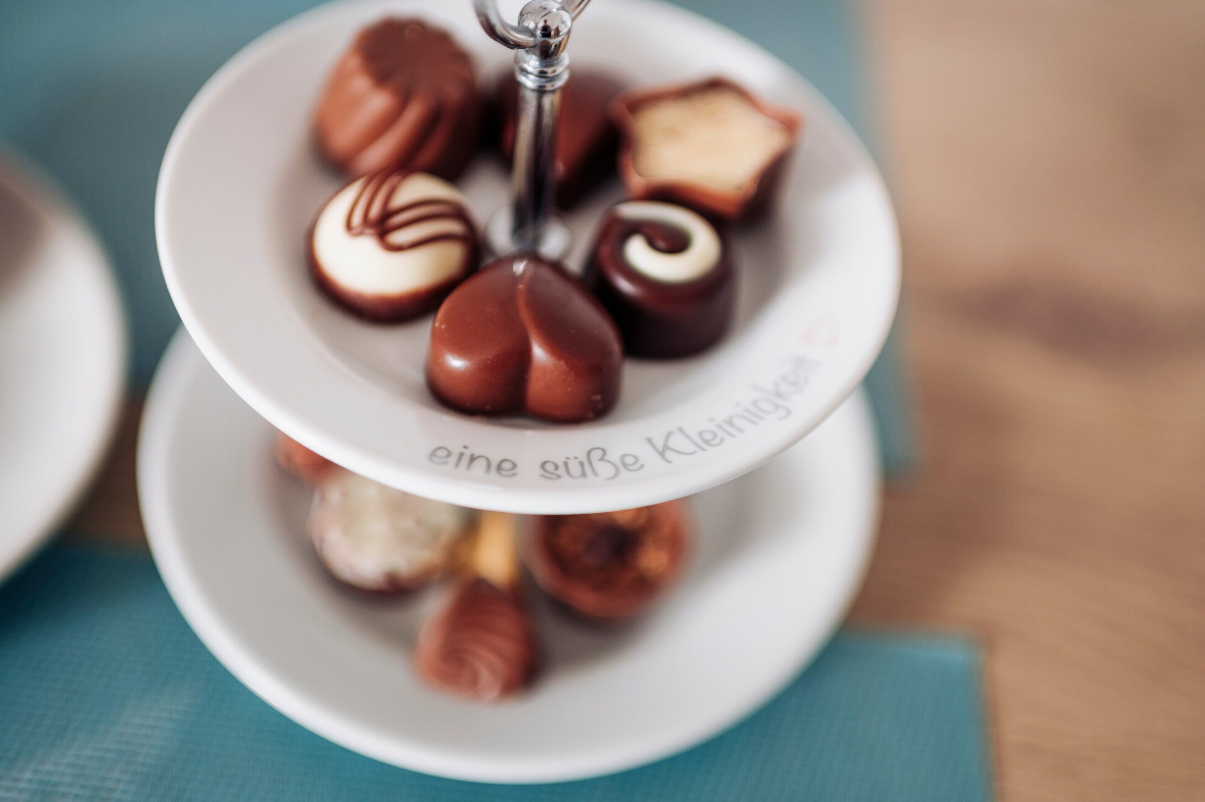 A plate with assorted chocolates on a white plate.