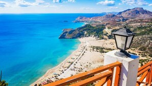 A coastal view with a beach, clear blue sea, and distant mountains. - Villa Metis in Rhodes (Rhodes)