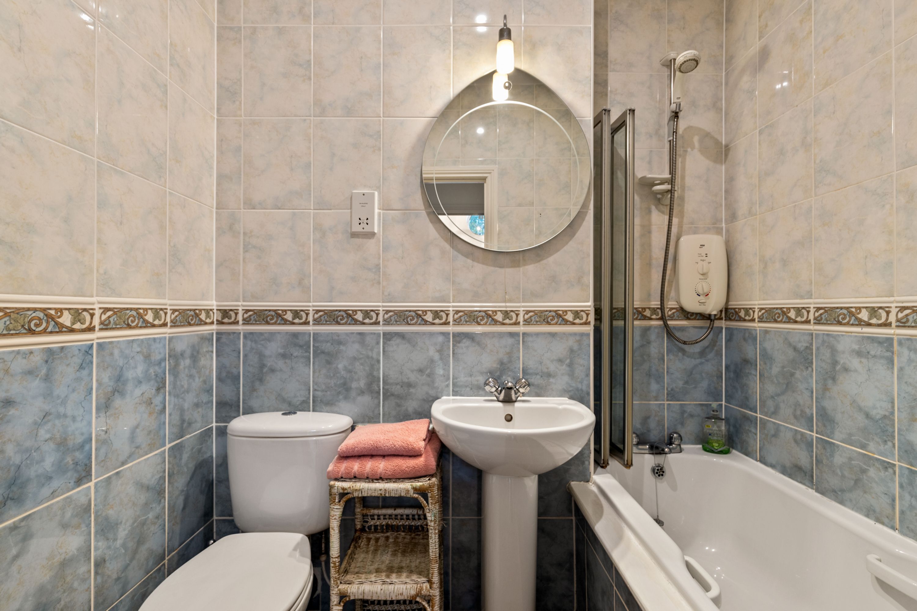A bathroom with a toilet, sink, and bathtub.