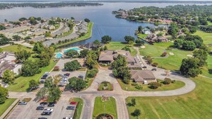 A residential area with a swimming pool, golf course, and a marina. - Lake Conroe Condo | Near Ren Fest + Waterfront Dining | Peaceful Porch + Gated Community (Montgomery)