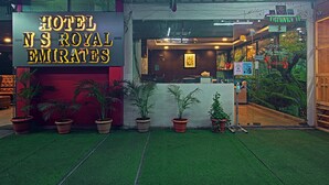 A hotel entrance with a neon sign reading "HOTEL NS ROYAL EMIRATES". - Hotel NS Royal Emirates (Hyderabad)