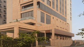 A modern building with a prominent corner design, large windows, and a flat roof. - Fortune Park, East Delhi - Member ITC Hotels' Group (New Delhi)