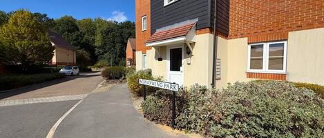 A residential street with a house labeled 'WAXWING PARK' and a paved driveway.