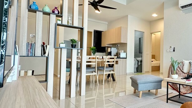 A modern living room with a wooden floor, a dining area with a wooden table and chairs, and a kitchen with wooden cabinets. - Ong Kim Wee Residence (Malacca City)