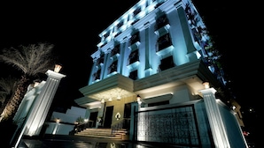 A multi-story building with a grand entrance, large columns, and a gated driveway. - M2 Square by Monday Premium (Nagpur)
