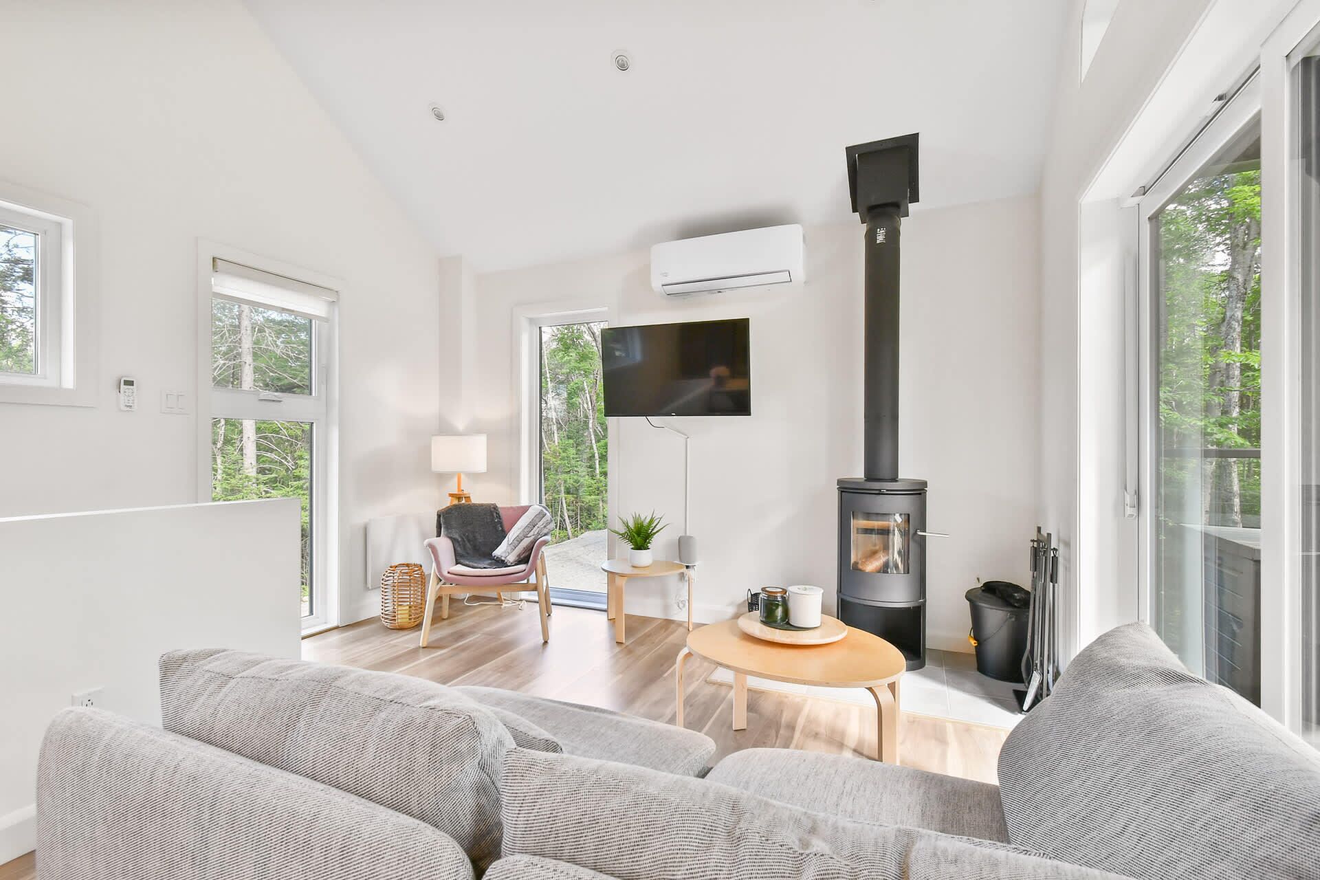 A modern living room with a fireplace, a TV, and a cozy seating area.