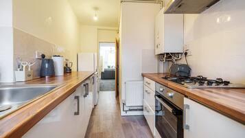 Executive Apartment, 2 Bedrooms | Private kitchen | Cleaning supplies, paper towels, dining tables