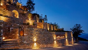 A stone building with a sign reading "Sunrise Garden Hills." - Sunrise Garden Hills (Zagora-Mouresi)