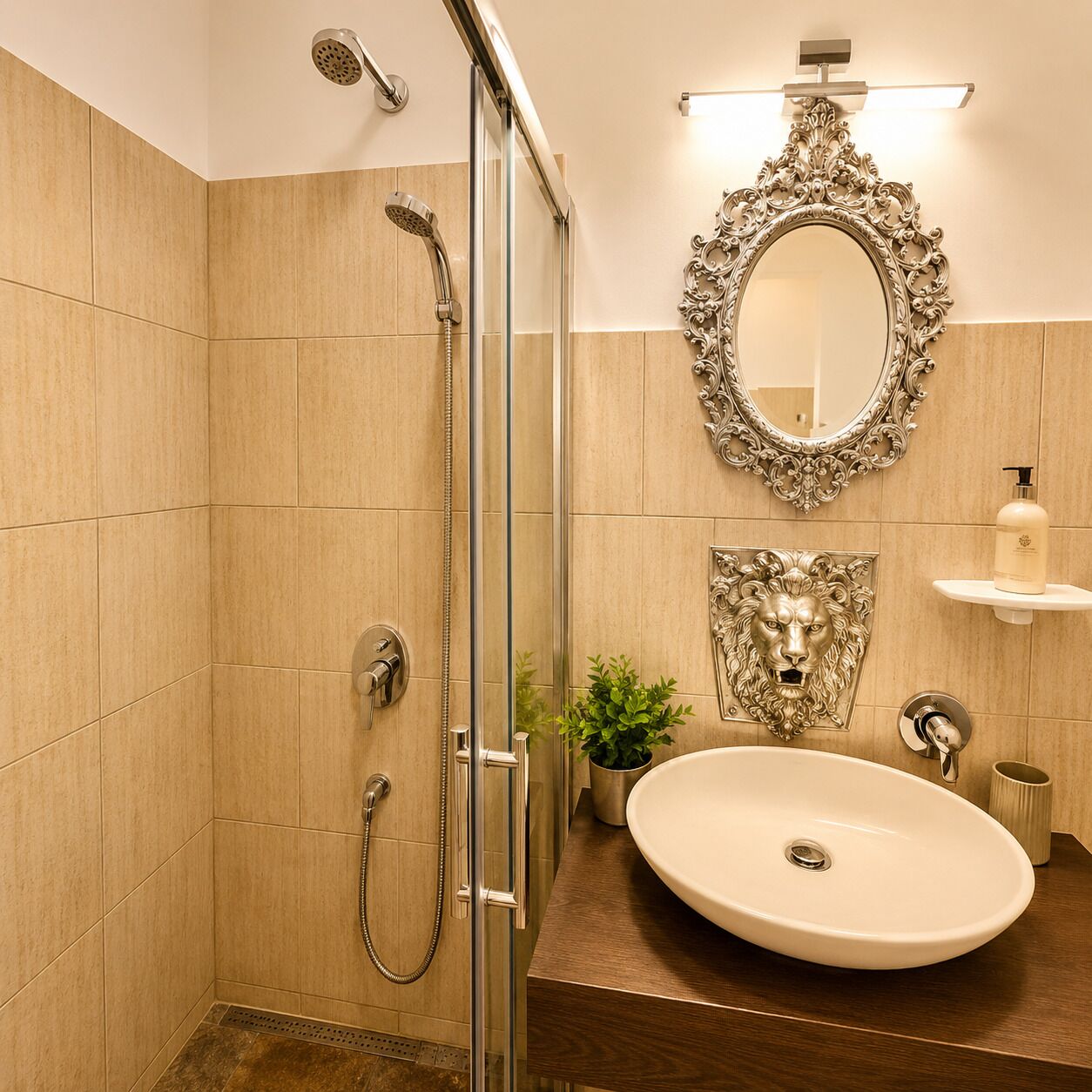 A bathroom with a glass-enclosed shower, a large mirror with an ornate frame, a sink with a pedestal, and a small plant.