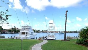 A marina with boats docked, a pathway leading to the water, and a clear sky. - Bay View #7 - 3 bedroom, 3.5-bath waterfront townhouse in a gated community in Rodney Bay 3 Townhouse by RedAwning (Gros Islet)