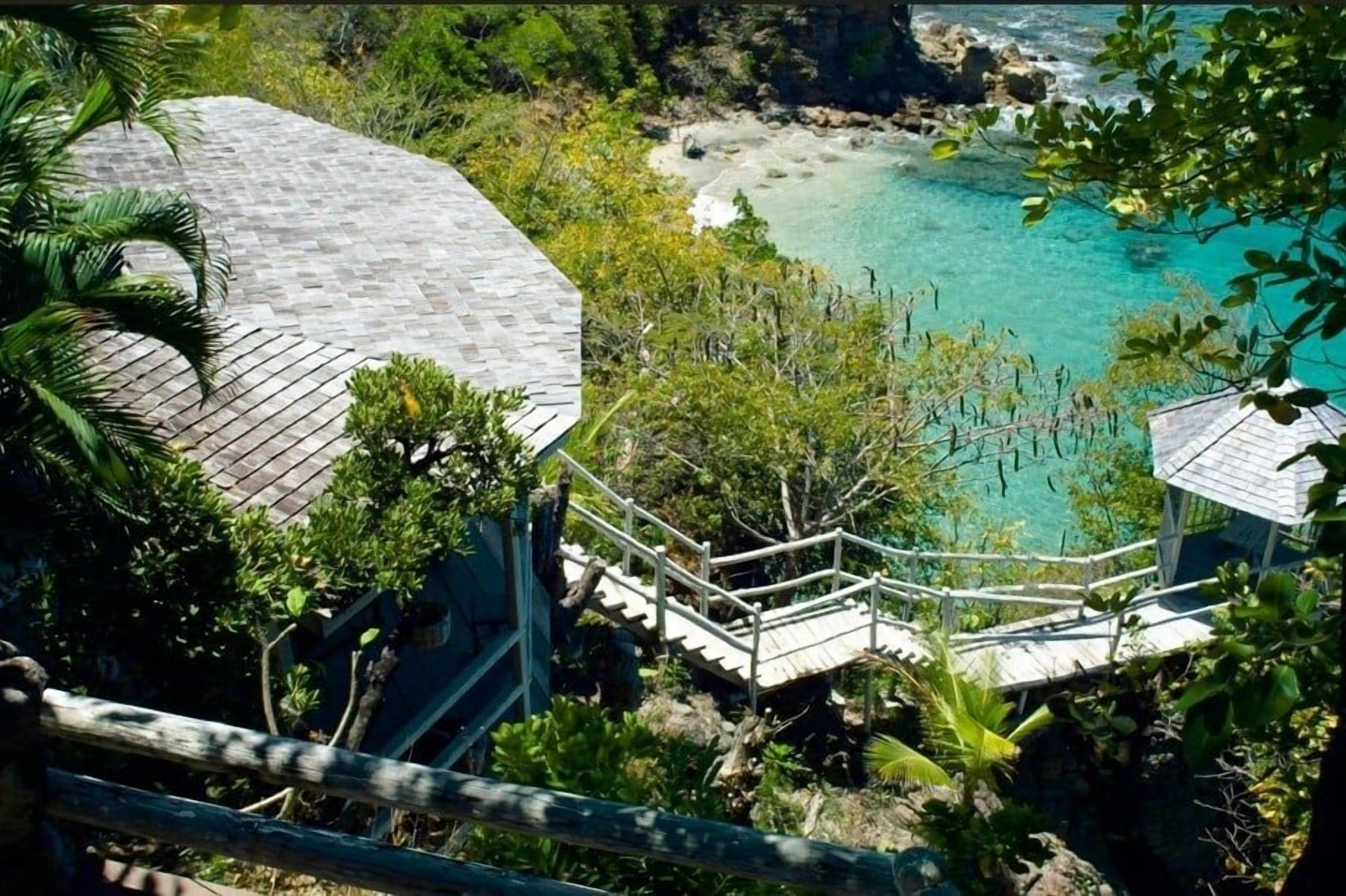 A coastal resort with a wooden staircase leading to a beach.