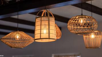 A series of hanging, woven light fixtures in a modern interior setting.