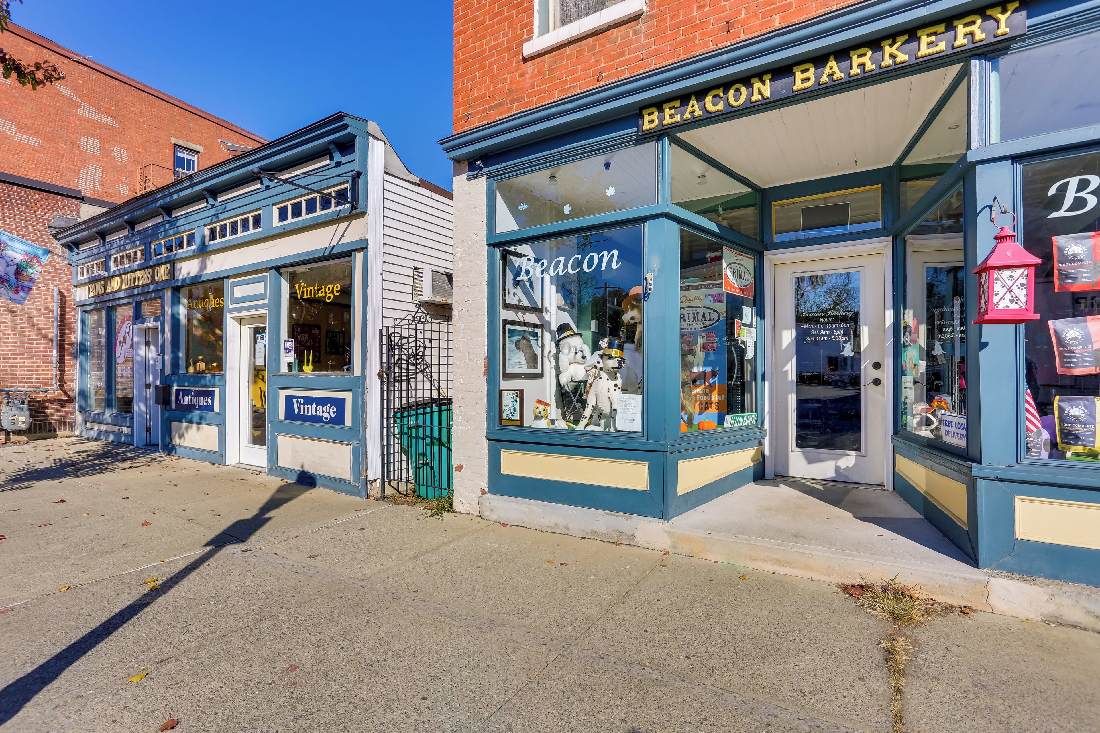 A storefront with a sign reading "Beacon Bakery" and another sign for "Antiques."
