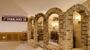 A room with brick arches, a wooden cabinet, and a wall-mounted sign. - Immaculate Boone Villa w/ Entertainment Lounge! (Boone)
