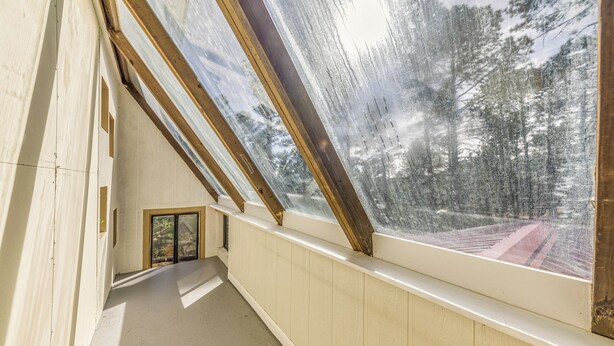 A corridor with skylights and a view of trees. - Ruidoso Retreat w/ Grill ~ 3 Mi to Grindstone Lake (Ruidoso)