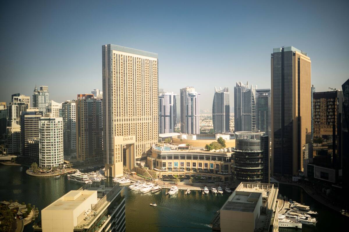 A high-rise hotel with a marina in the foreground.