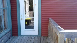A red exterior with a white door and a small porch area. - 6 bedroom 2 bath country retreat
 (New Brunswick)