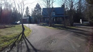 A residential street with houses, trees, and a clear sky. - 6 bedroom 2 bath country retreat
 (New Brunswick)