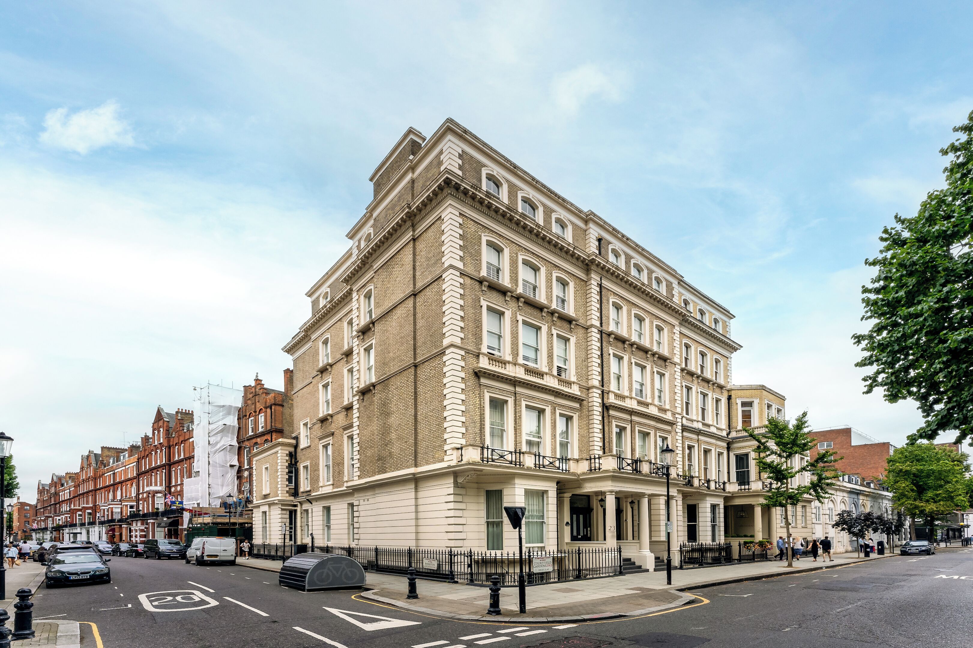 A multi-story building with a classic architectural style, featuring a prominent corner entrance and a series of windows.