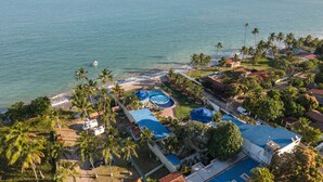 A coastal hotel with a pool area, beach access, and palm trees. - Pousada Mansão da Costa (Maragogi)