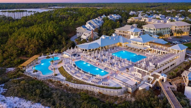 A resort with multiple swimming pools, a covered outdoor area, and a view of the surrounding forest. - Close to Parks with Private Pool and Bikes (Santa Rosa Beach)