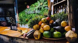 A variety of fruits and vegetables displayed at a counter with a sign reading "Sabaloa". - Babalao Bungalows (Nungwi)