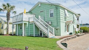A two-story house with a white staircase, a covered porch, and a small front yard. - Beach Life Down, Oceanview Duplex in Atlantic Beach, NC! (Atlantic Beach)