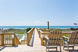 A wooden boardwalk leading to beach chairs with an American flag. - Beach Music, Oceanfront House in Emerald Isle, NC! (Emerald Isle)